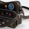 Bolso bandolera Dakota del 10.º aniversario de Rexy en piel desgastada con estampado de pegatinas