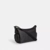 Bolso bandolera Finn con bolsillos en Signature Canvas