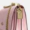 Bolso bandolera Klare en Signature Canvas con Charms