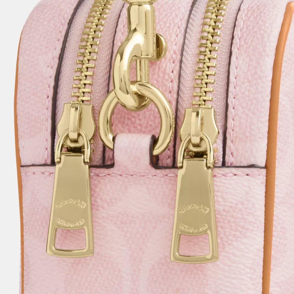 Bolso bandolera Mini Carey en Signature Canvas con Charms