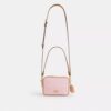 Bolso bandolera Mini Carey en Signature Canvas con Charms