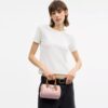 Bolso bandolera Mini Rowan en Signature Canvas con Charms