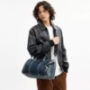 Bolso Compass 35 en denim de algodón regenerativo con Charms