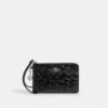 Bolso de pulsera con cremallera en la esquina, en piel exclusiva con Charms en forma de corazón