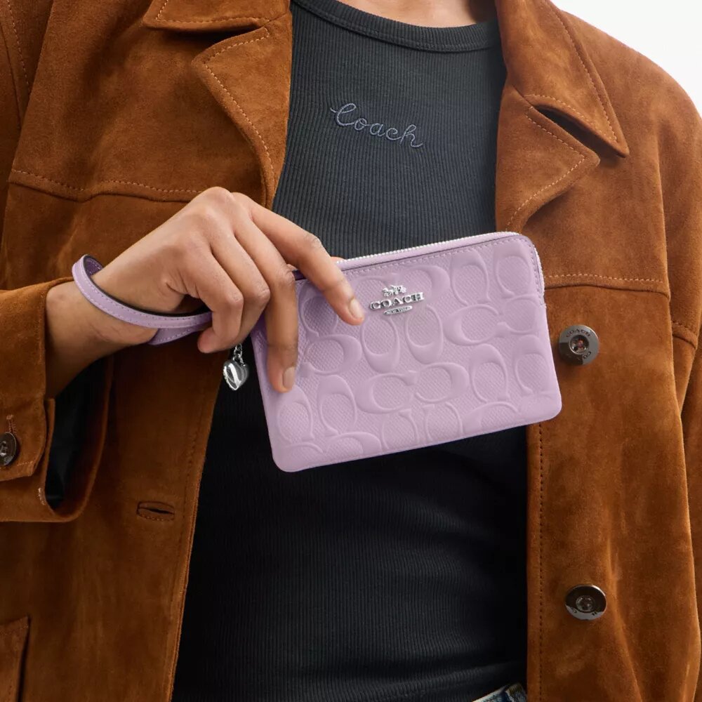 Bolso de pulsera con cremallera en la esquina, en piel exclusiva con Charms en forma de corazón