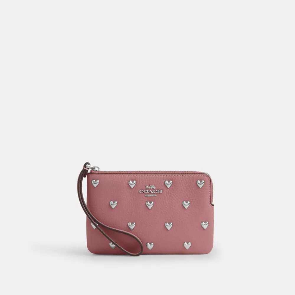 Bolso de pulsera con cremallera en la esquina y remaches en forma de corazón