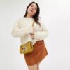 Bolsos Swinger de Disney x Coach en piel regenerativa con Mickey Mouse y sus amigos
