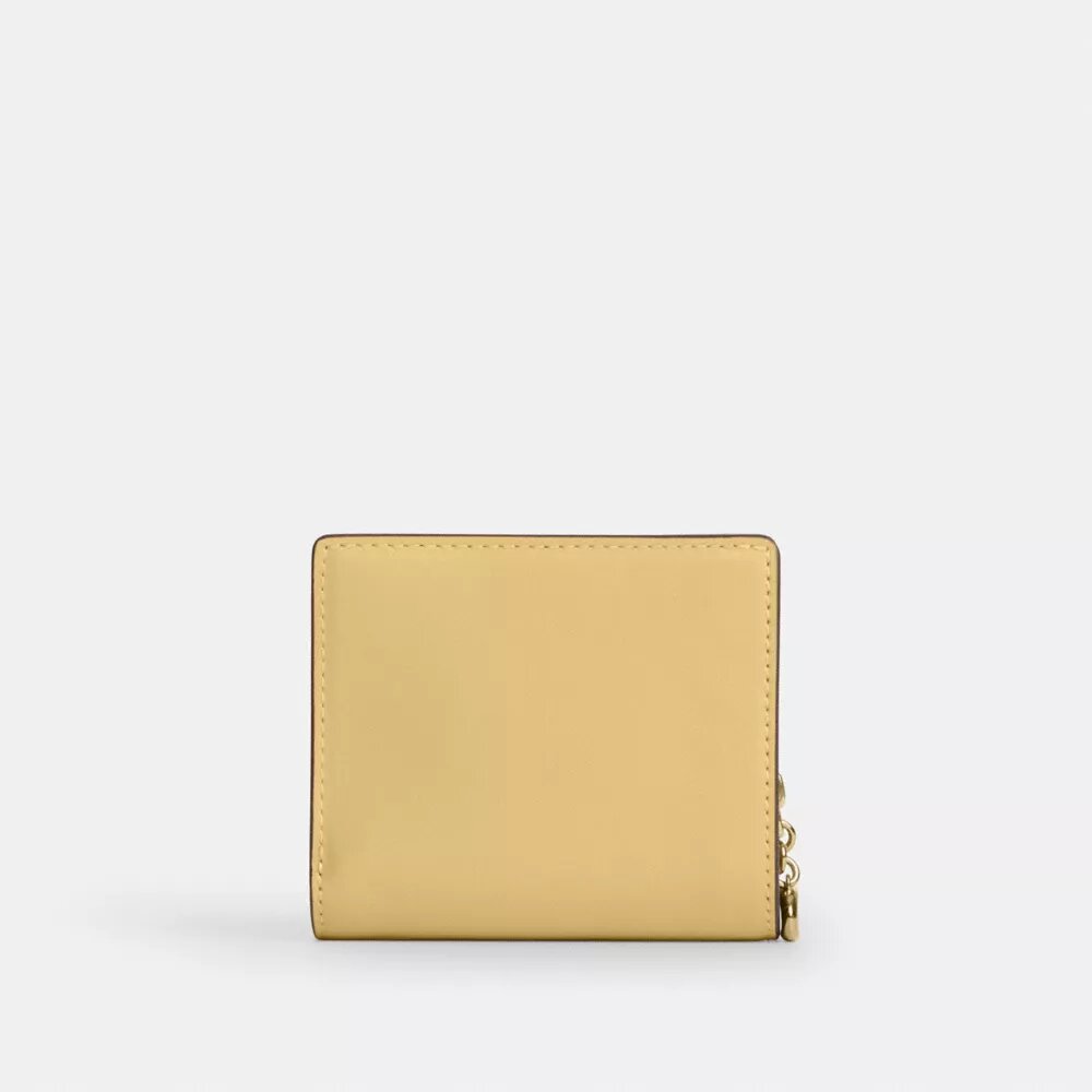 Cartera con cierre a presión y Charms