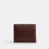 Cartera con cierre a presión y Charms