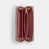 Cartera larga con cremallera perimetral en Signature Canvas