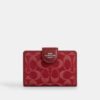 Cartera mediana con cremallera en las esquinas en denim característico