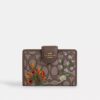 Cartera mediana con cremallera en las esquinas, en jacquard exclusivo con bordado floral