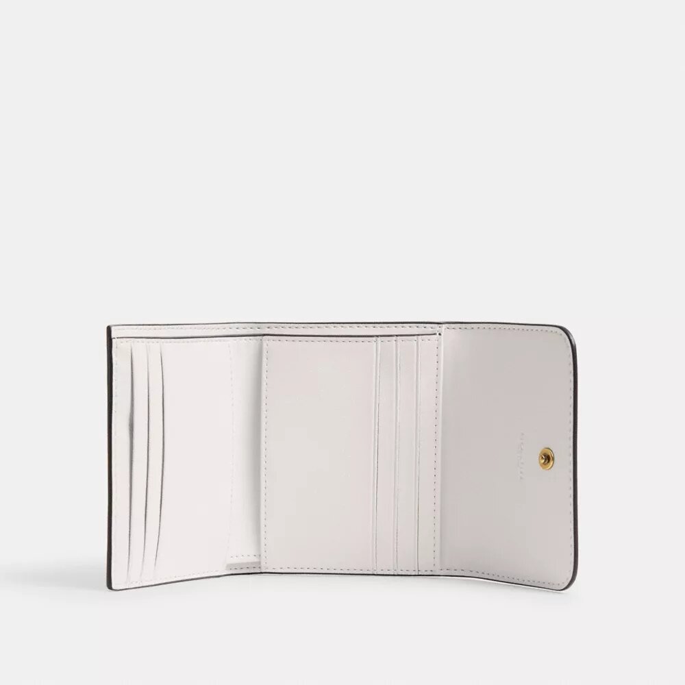 Cartera pequeña con solapa Mila y estampado de pegatinas