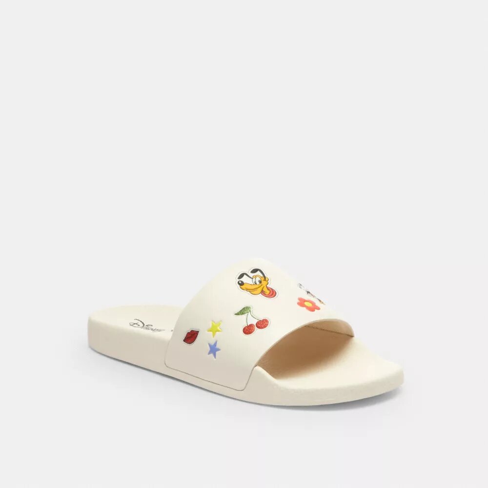 Chanclas deportivas Udele de Disney X Coach con estampado de pegatinas