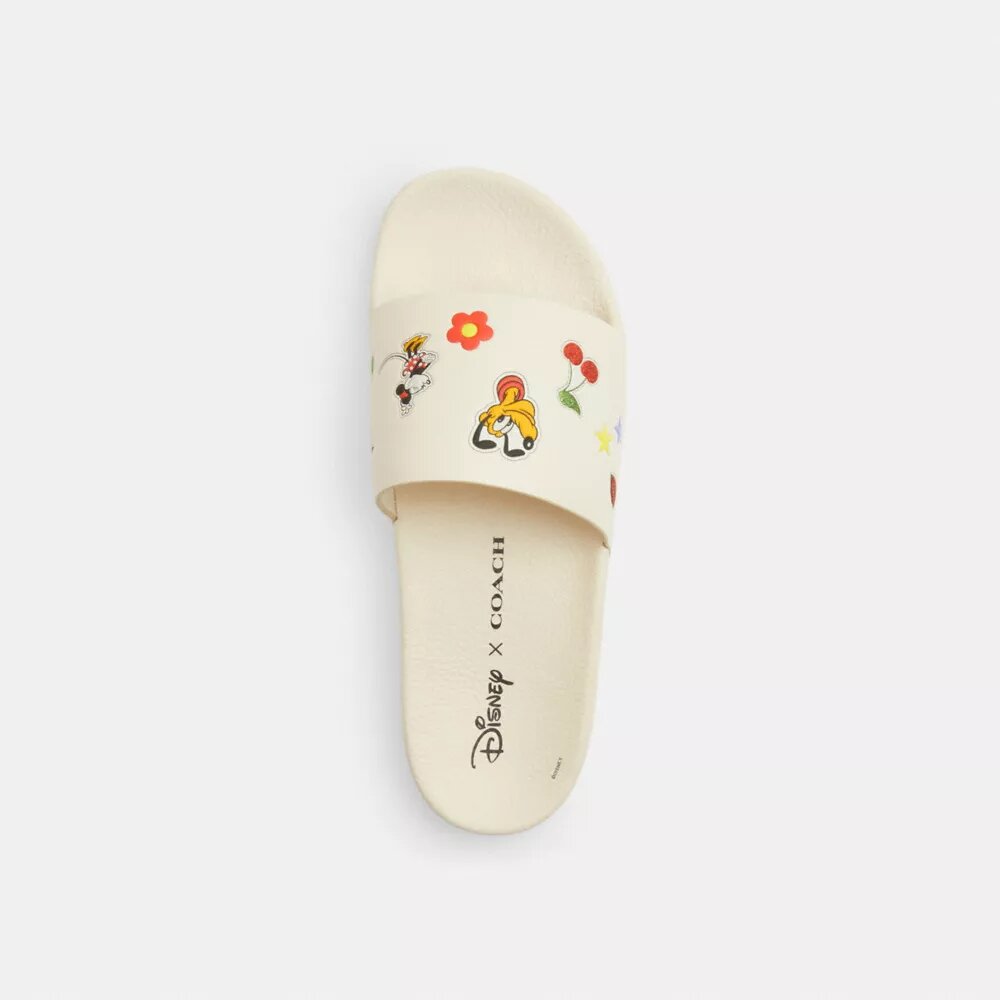 Chanclas deportivas Udele de Disney X Coach con estampado de pegatinas
