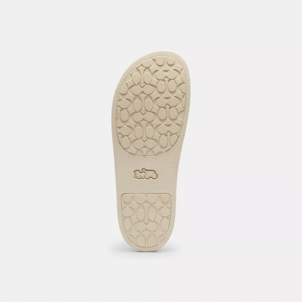 Chanclas deportivas Udele de Disney X Coach con estampado de pegatinas