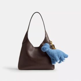 Colgante para bolsos «Buddy Dinosaur» de Rexy, con motivo del 10.º cumpleaños, en piel de oveja