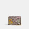 Mini cartera con cadena en jacquard exclusivo con bordado floral