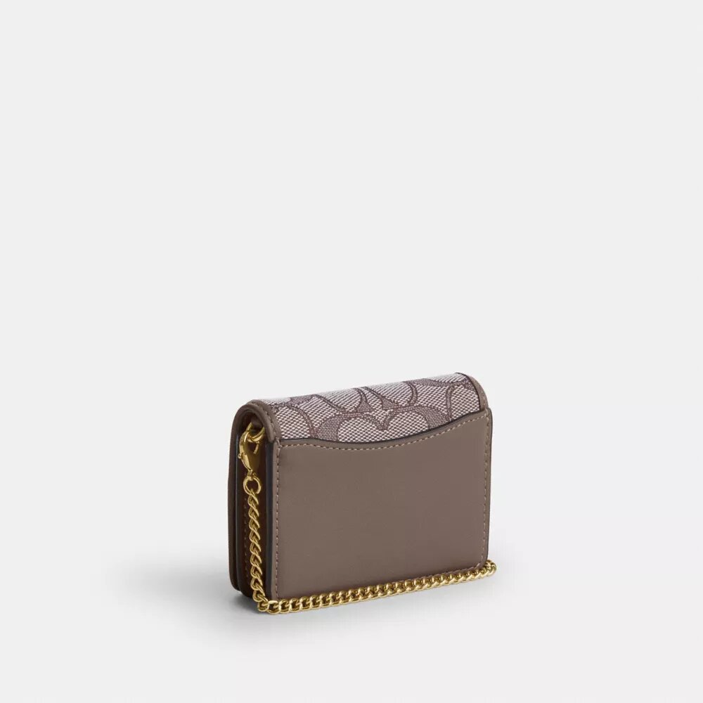 Mini cartera con cadena en jacquard exclusivo con bordado floral