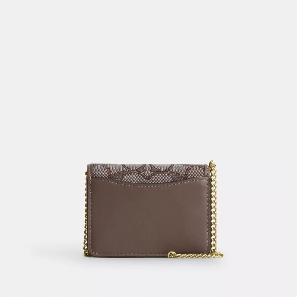 Mini cartera con cadena en jacquard exclusivo con bordado floral