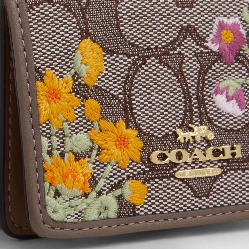 Mini cartera con cadena en jacquard exclusivo con bordado floral