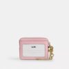 Tarjetero con cremallera en denim característico con Charms